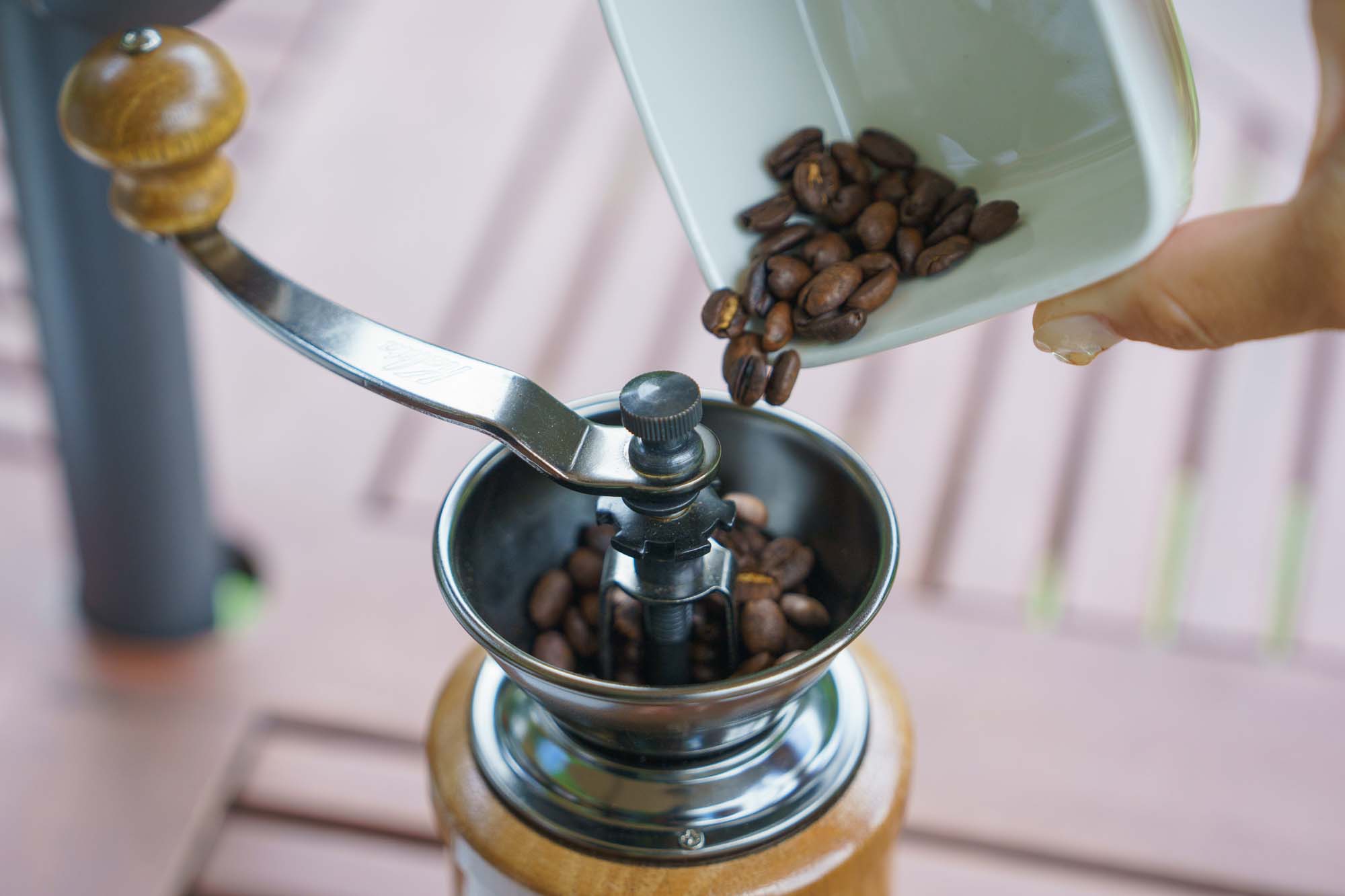 Transfer the beans to a hand mill for grinding.